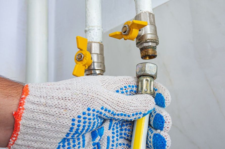 Licensed plumber repairing a residential gas line valve in Los Angeles