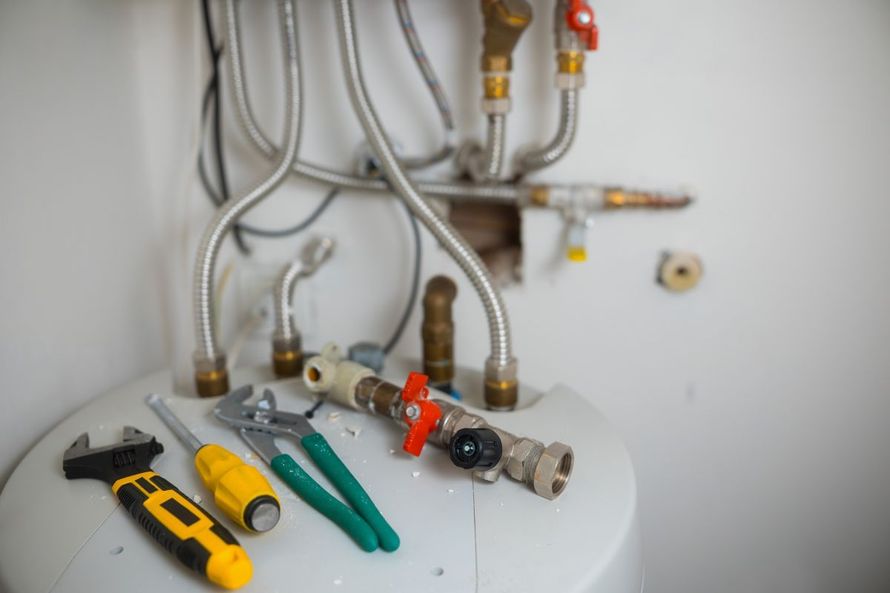 Water heater installation with professional plumbing tools by Pedro's Plumbing in Los Angeles