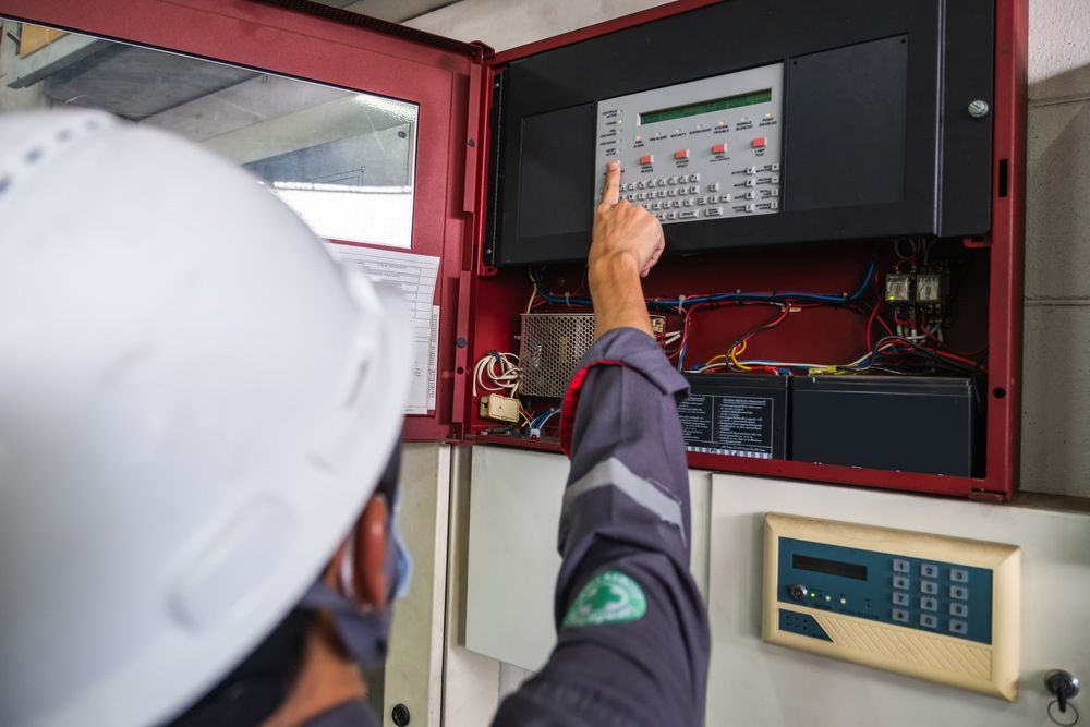 Technician inspecting power board — Level 2 Electrician in Newcastle NSW