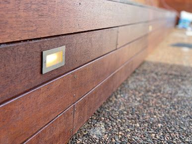 A Close Up Of A Wooden Wall With A Light On It — PRO Solar & Electrical In Newcastle, NSW
