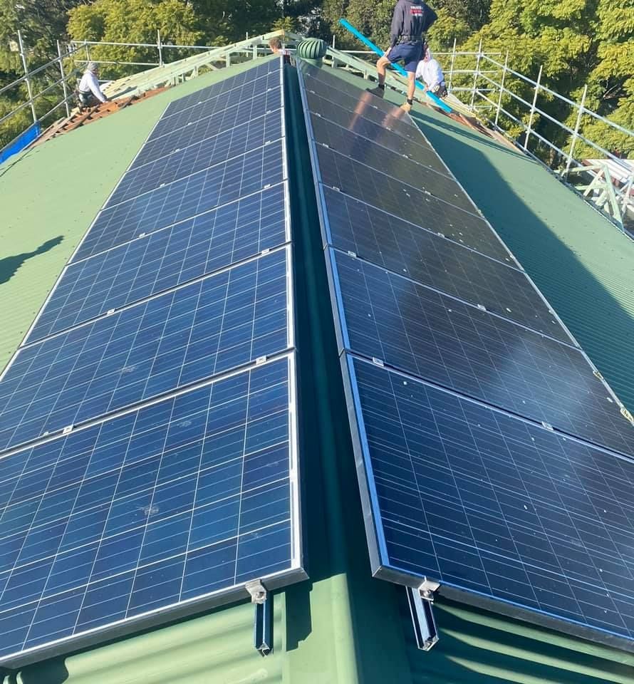 A Man Installing The  Outdoor Solar Cell — PRO Solar & Electrical In Newcastle, NSW