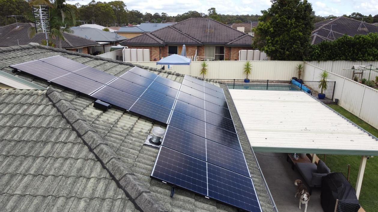 A Row Of Solar Panels On The Roof Of A House — PRO Solar & Electrical In Lake Macquarie, NSW