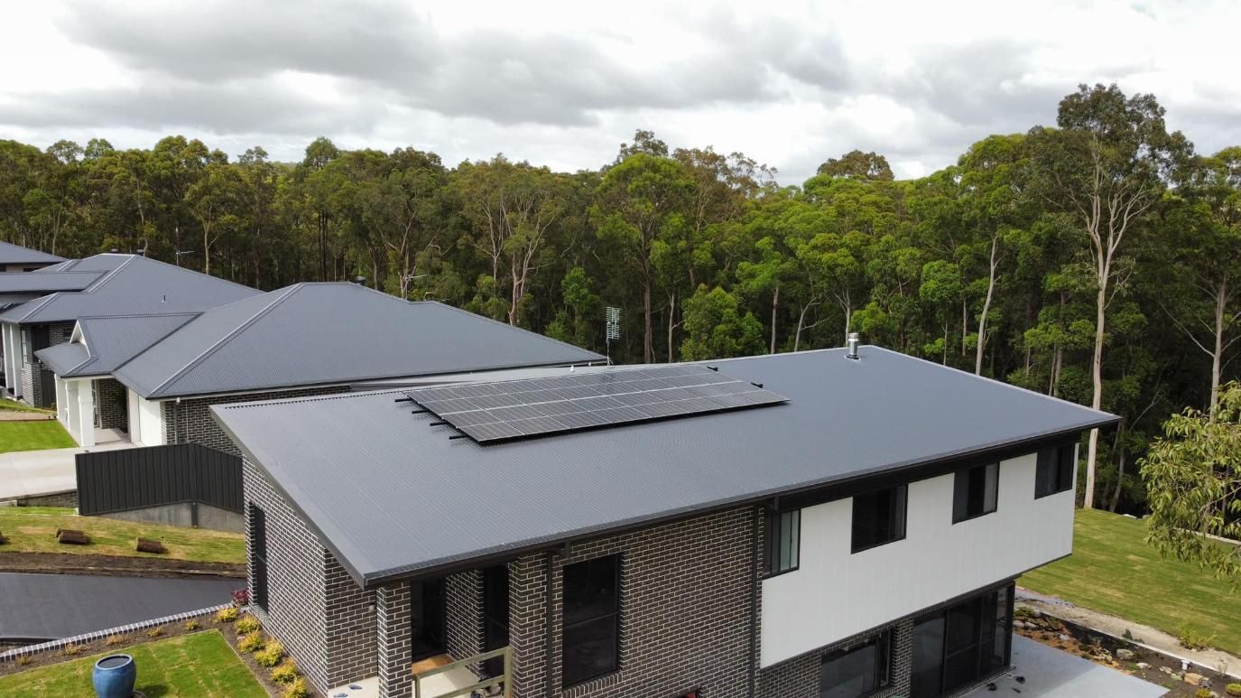 An Aerial View Of A House With Solar Panels On The Roof — PRO Solar & Electrical In Maitland, NSW