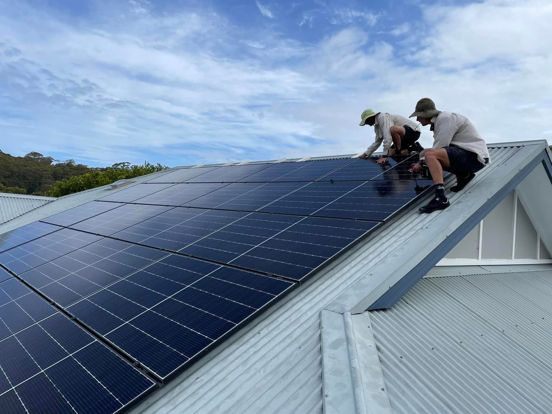 Two Man Installing A Solar Cell On A Roof — PRO Solar & Electrical In Maitland, NSW