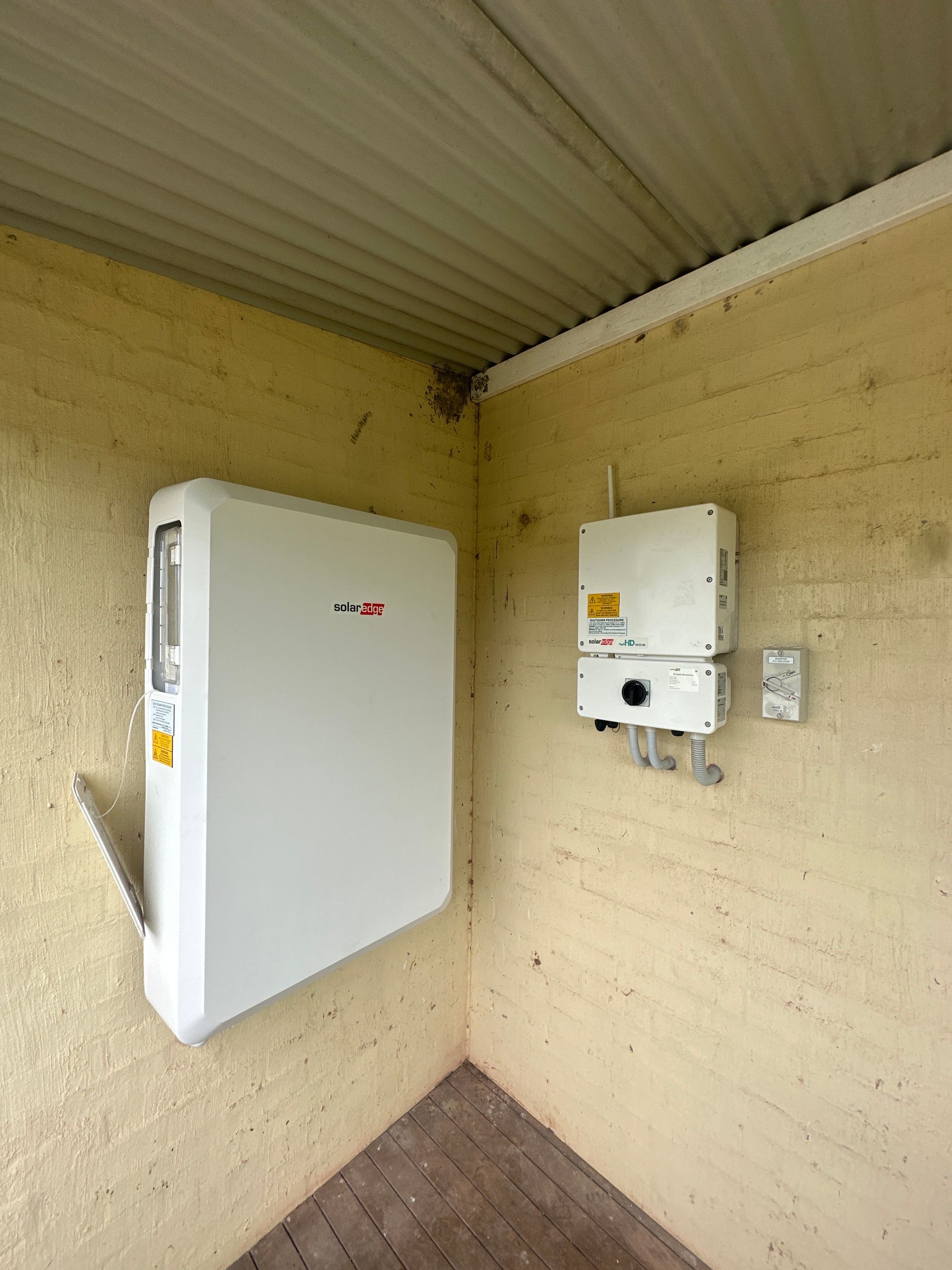 Battery Installed on the Yellow Wall— PRO Solar & Electrical In Lake Macquarie, NSW