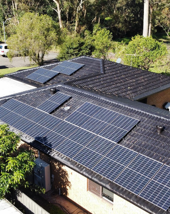 A House With A Lot Of Solar Panels On The Roof Pin Icon — PRO Solar & Electrical In Lake Macquarie, NSW