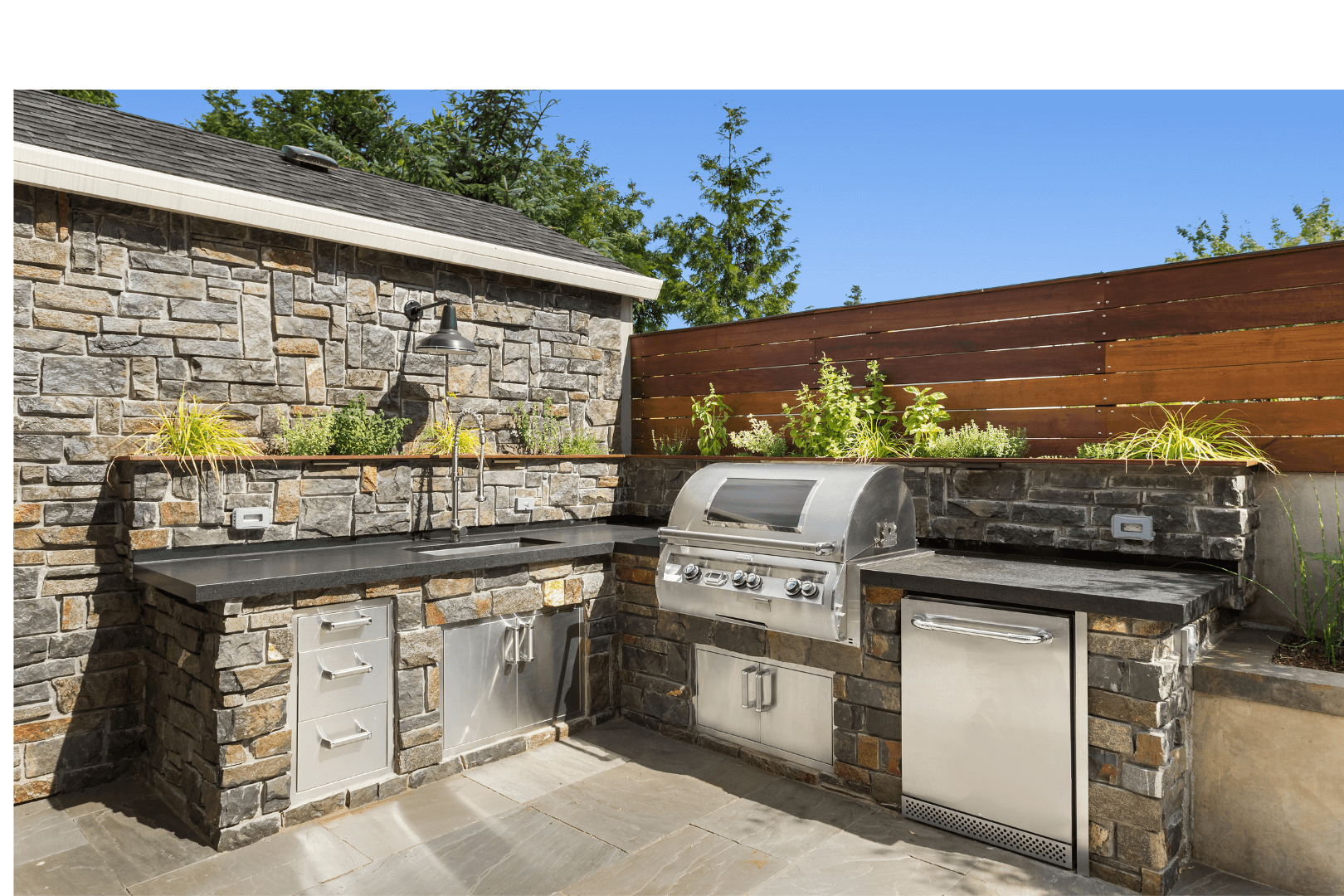 Cracked concrete driveway in front of a two-car garage. The driveway shows significant cracking, with a house and lawn in the background.