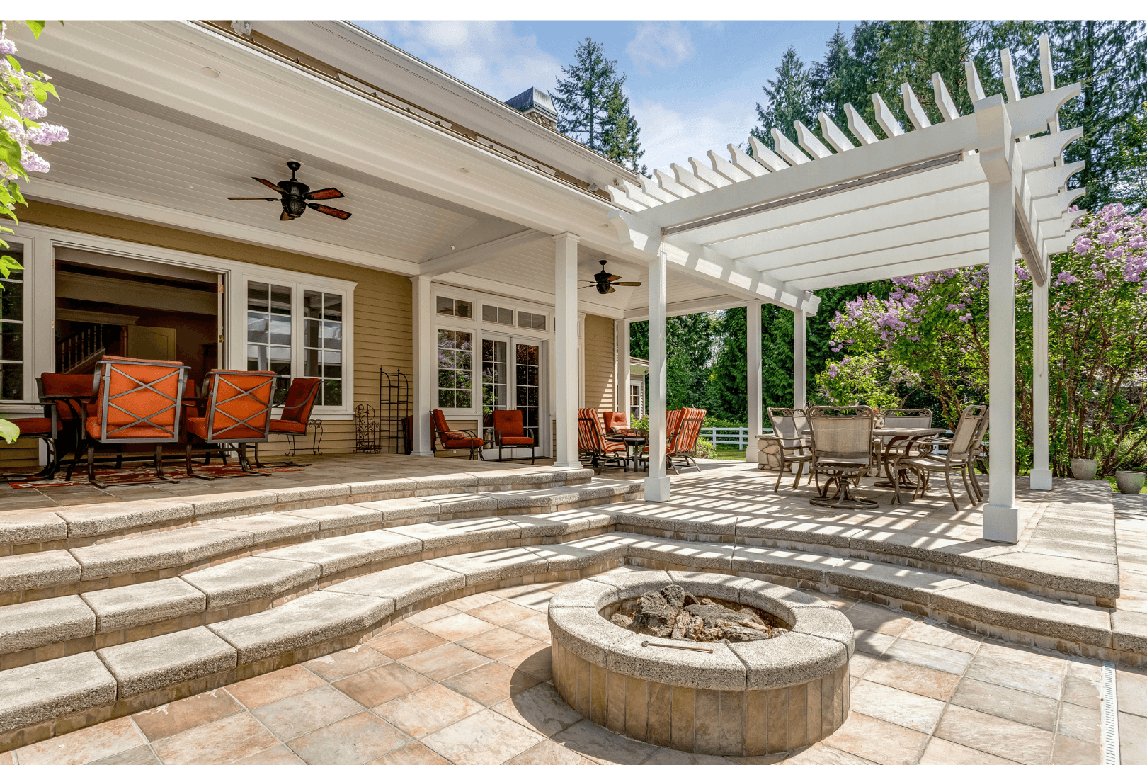 Cracked asphalt driveway in front of a two-car garage of a suburban home on a sunny day.