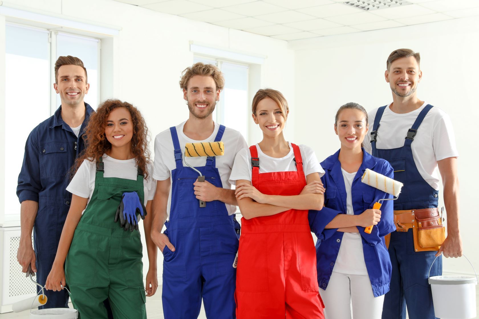 A Group Of Workers Are Posing For A Picture In A Room