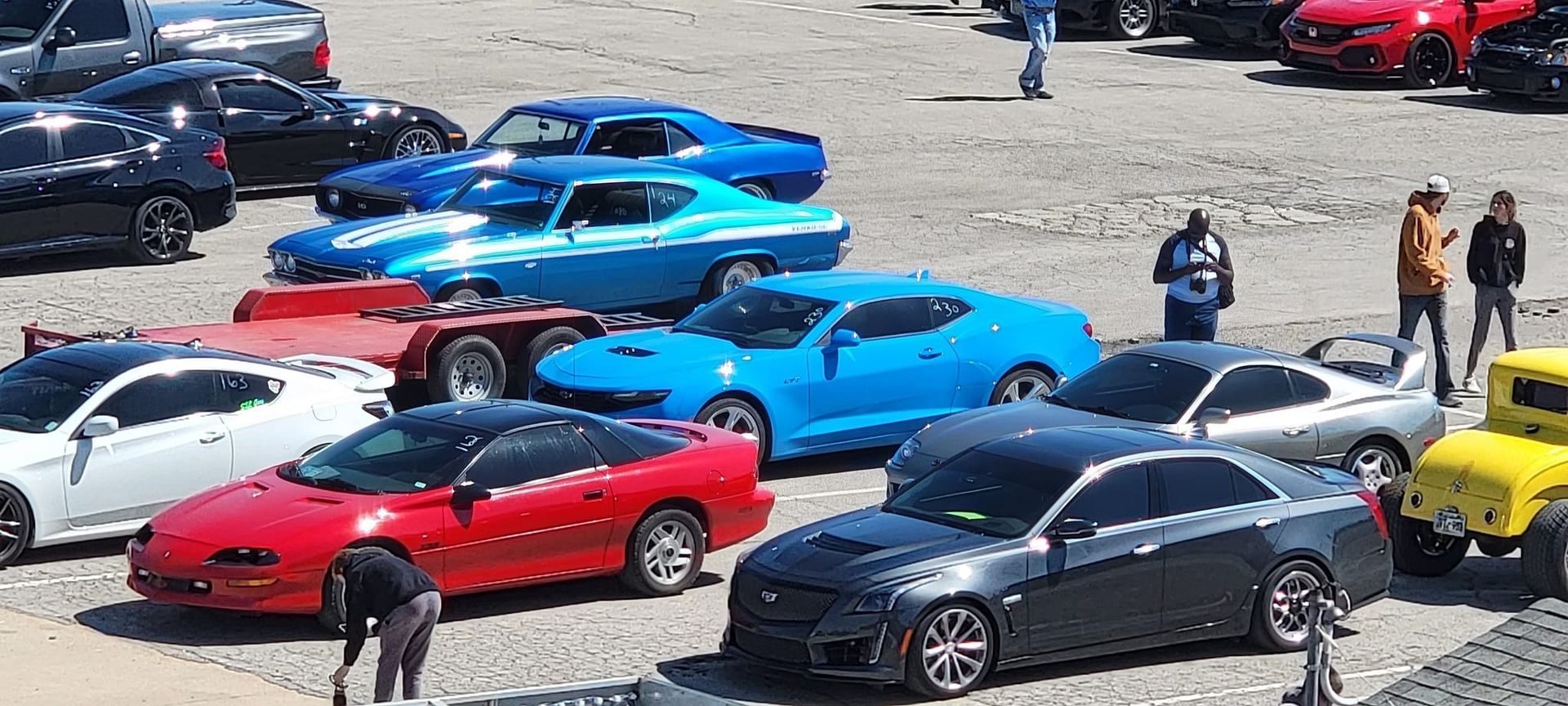 A group of cars are parked in a parking lot.
