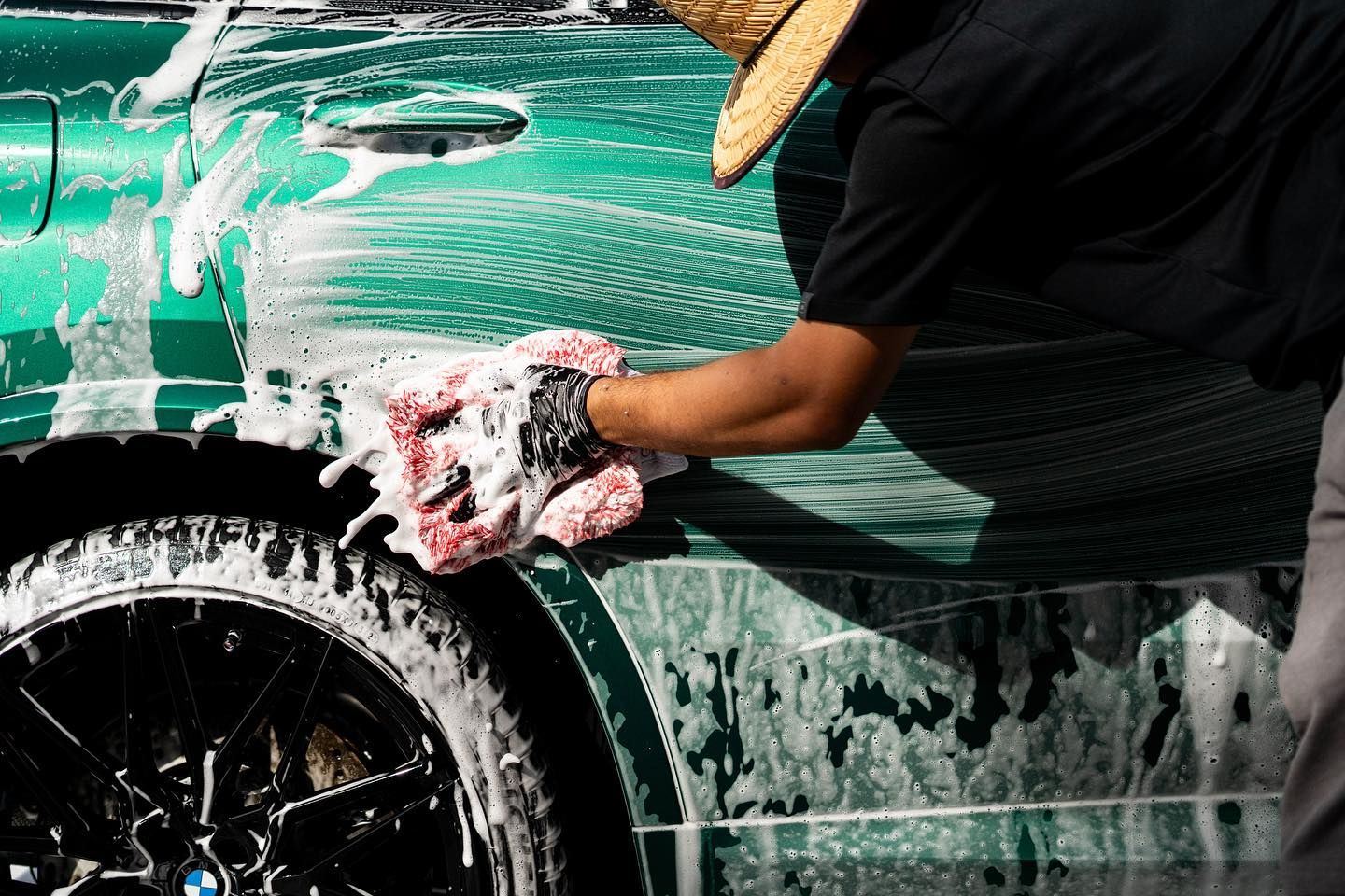 A light gray Hyundai Ioniq 5 electric car parked on a paved driveway in front of a house on a sunny day.