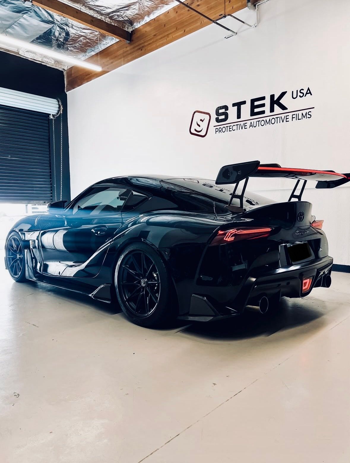 Silver Hyundai Ioniq 5 parked in a driveway. The car has black wheels and tinted windows.