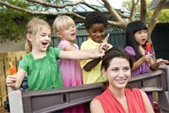 Young Diverse Preschool Children Playing in Daycare With Teacher - Learning center in Warwick, RI