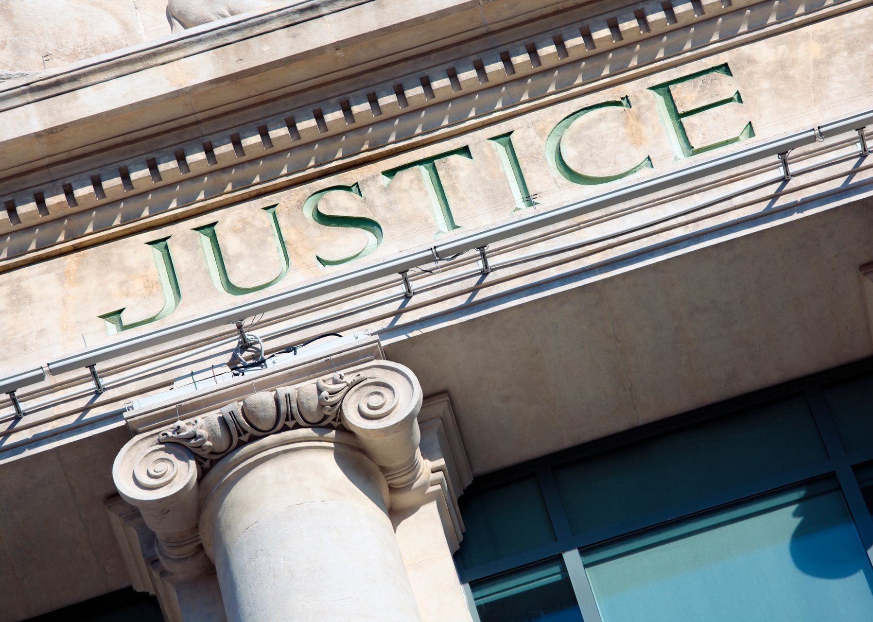 The word justice is on the front of a building