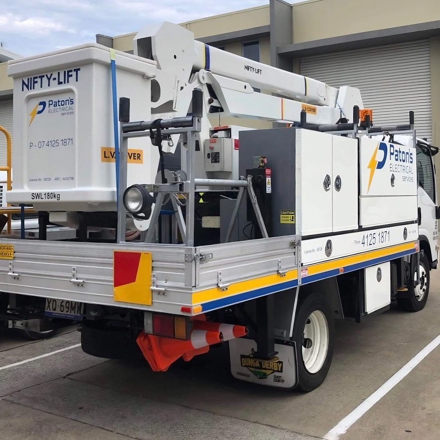 A Lift Truck Is Parked In A Parking Lot — Paton's Electrical Services in Urraween, QLD