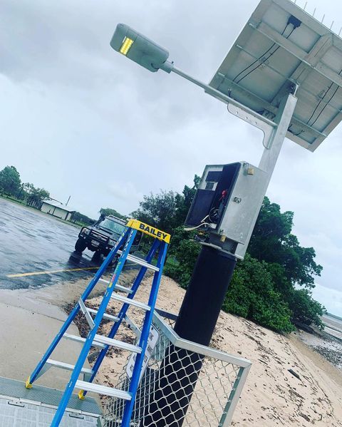 A Blue Ladder Next To An Electrical Box — Paton's Electrical Services in Kawungan, QLD