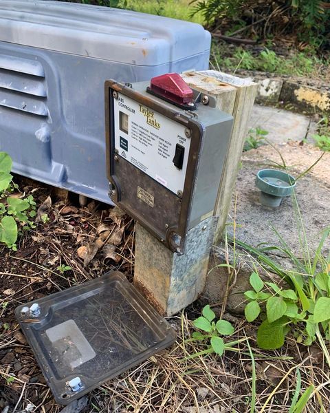 An Old Electrical Box Is Sitting on Top of A Concrete Post — Paton's Electrical Services in Urraween, QLD
