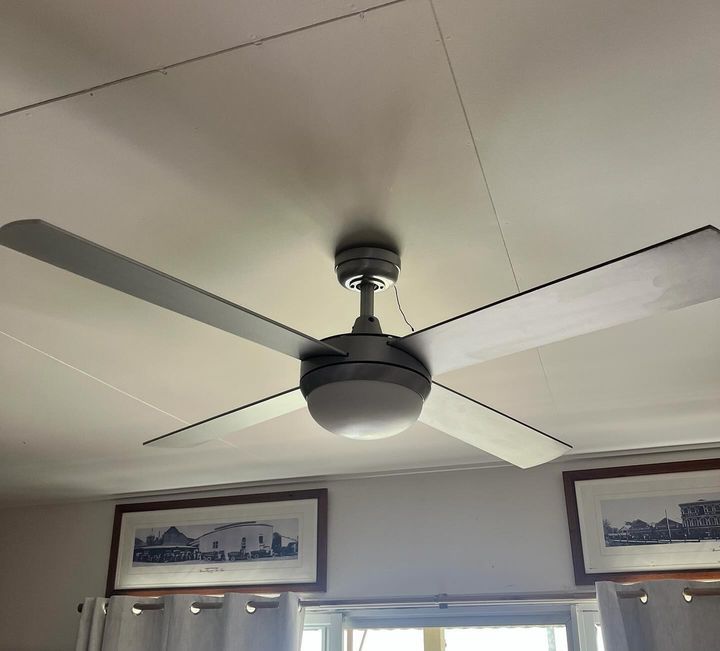 A Ceiling Fan Is Hanging from The Ceiling of A Room — Paton's Electrical Services in Kawungan, QLD