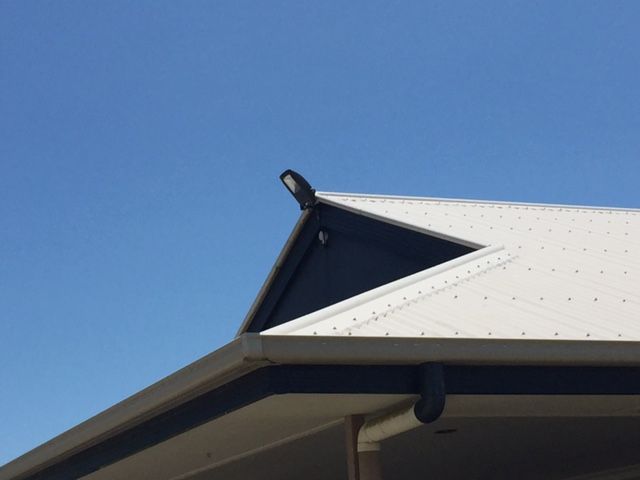 A Black and White Roof with A Blue Sky in The Background — Paton's Electrical Services in Kawungan, QLD