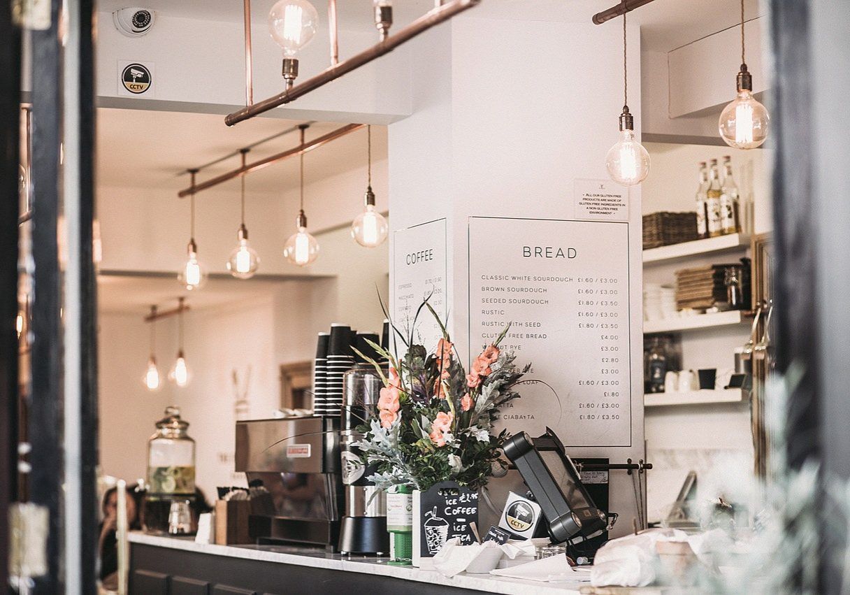 A Kitchen with White Cabinets — Paton's Electrical Services in Urraween, QLD