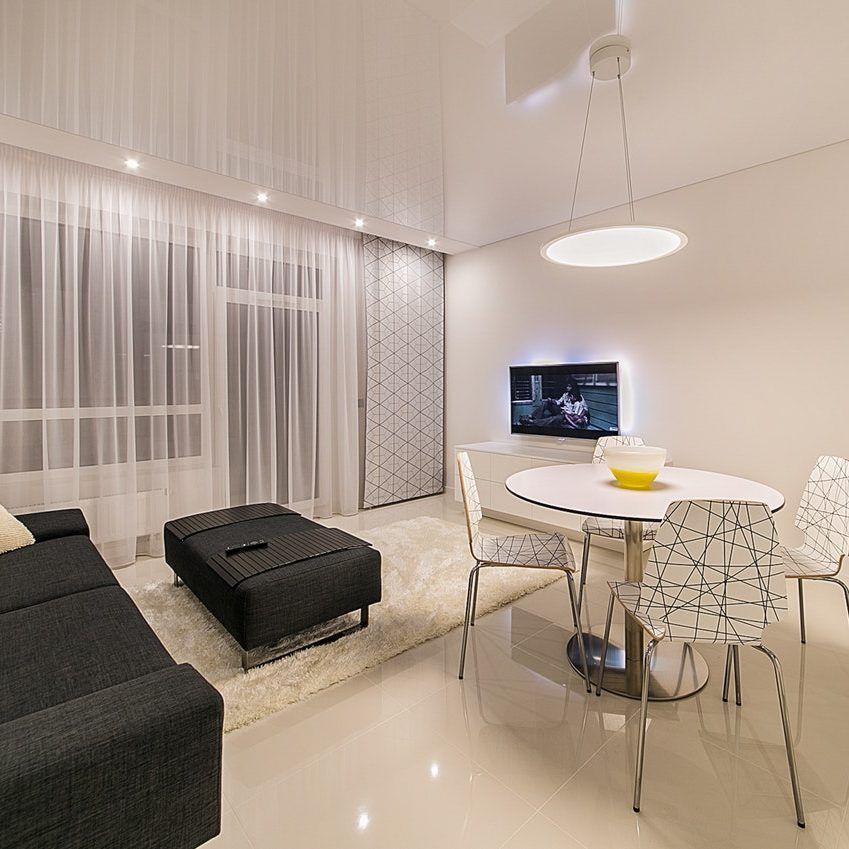 A Living Room with A Couch and A Table and Chairs — Paton's Electrical Services in Pialba, QLD