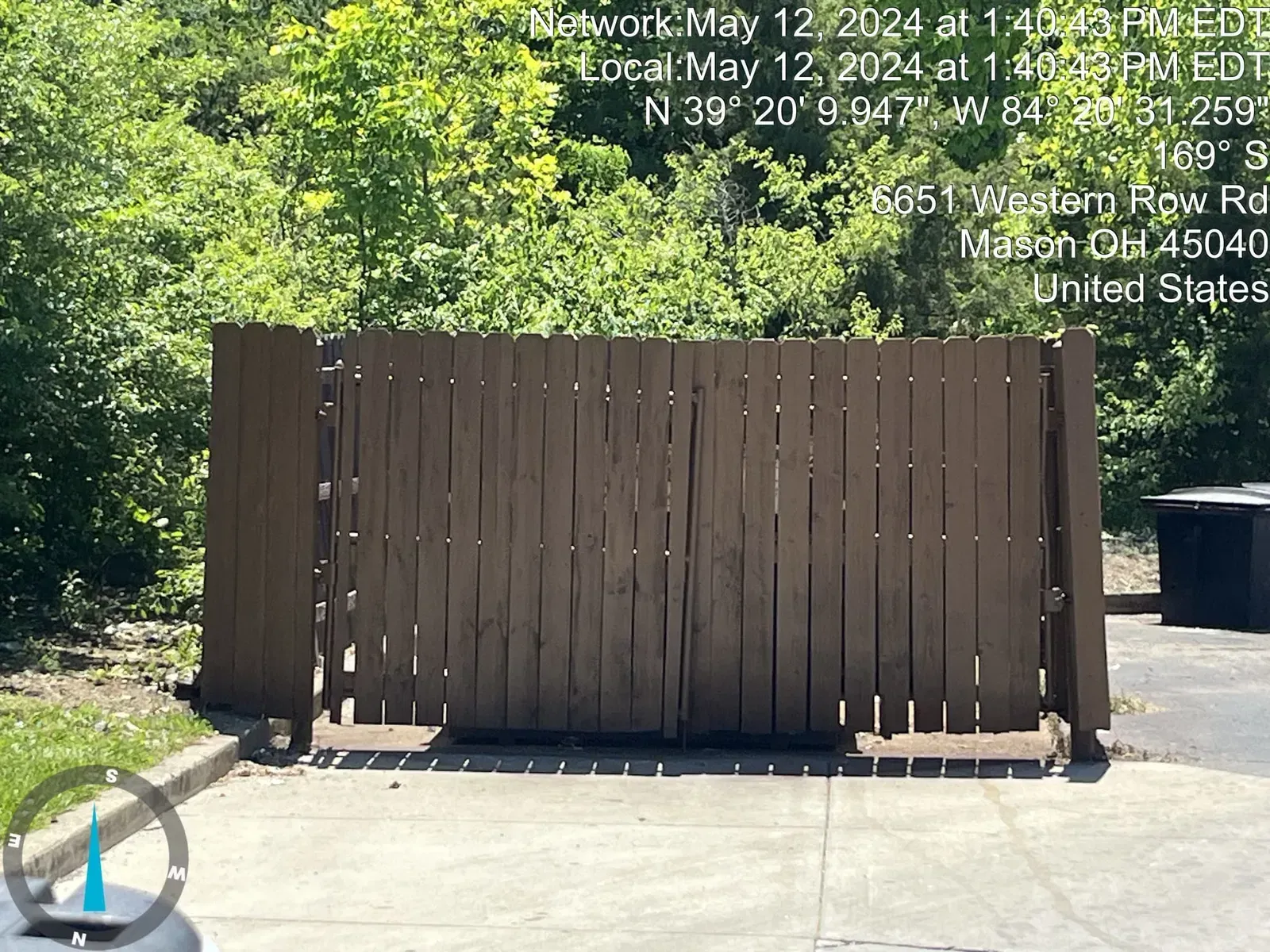 A wooden fence with a brown finish. Text overlay indicates date, time, and location.