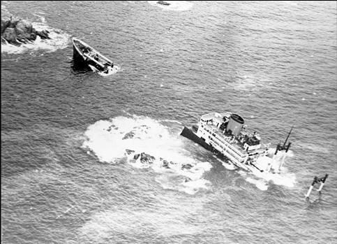 A black and white photo of two boats in the ocean