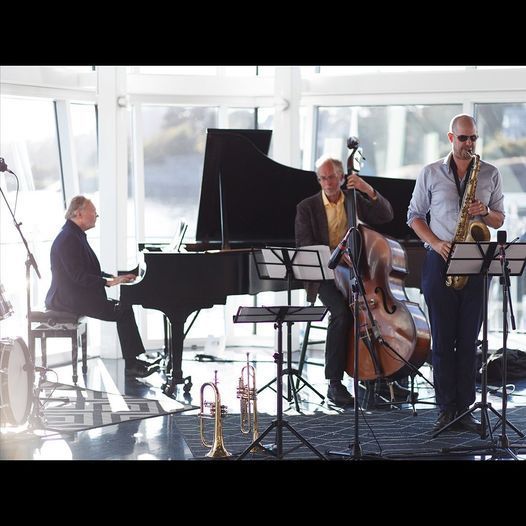 A man is playing a piano and a man is playing a saxophone