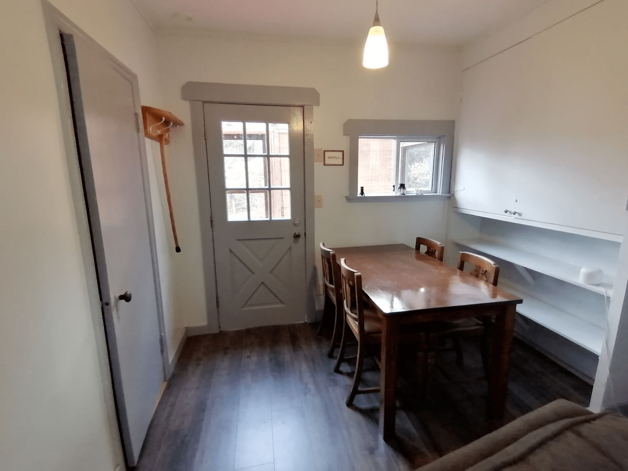 A room with a table and chairs and a door