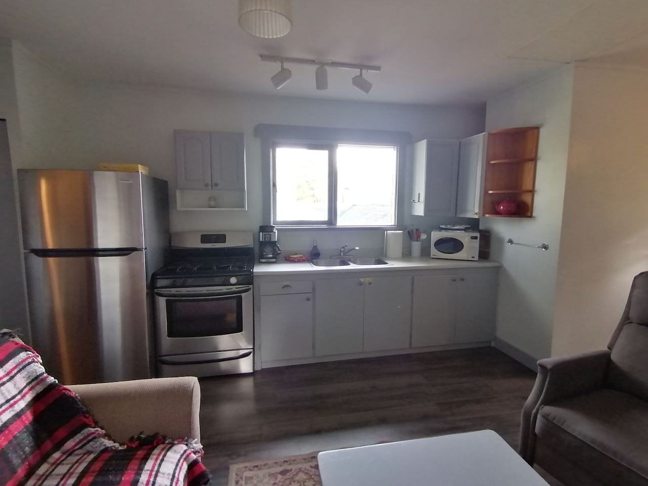 A kitchen with stainless steel appliances and white cabinets