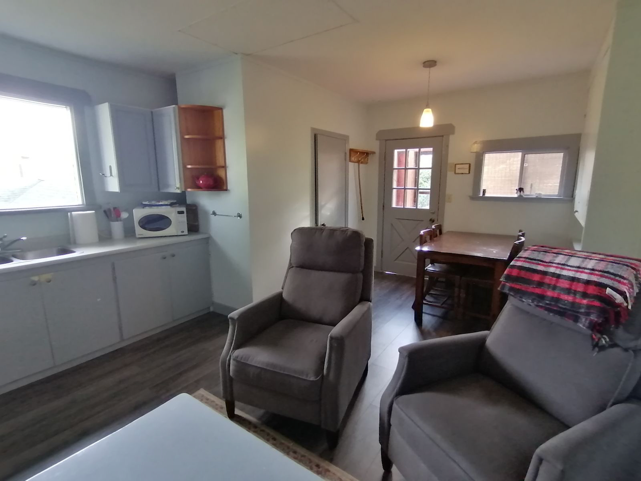 A living room with two chairs and a table