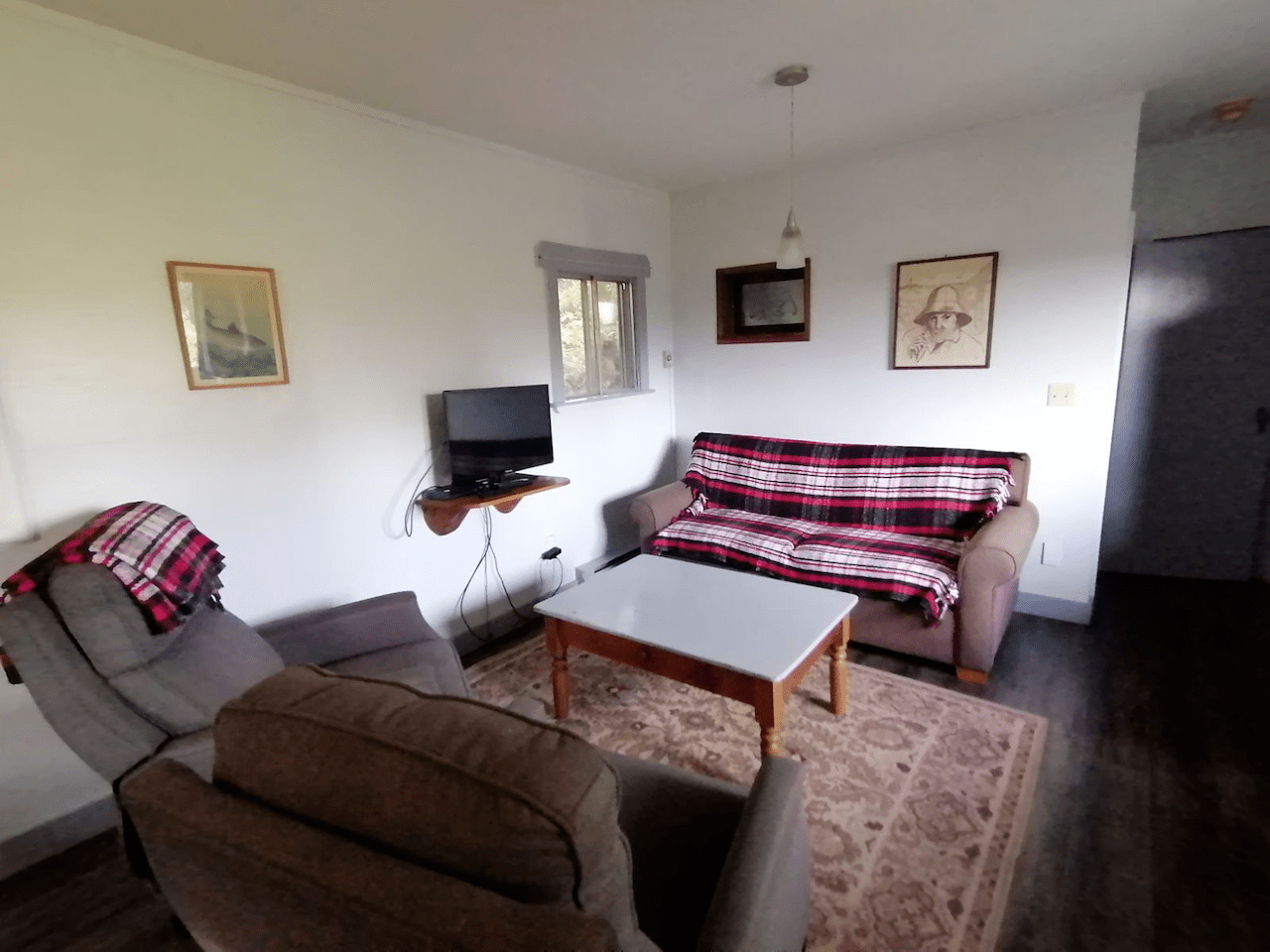 A living room with a couch and chairs and a table