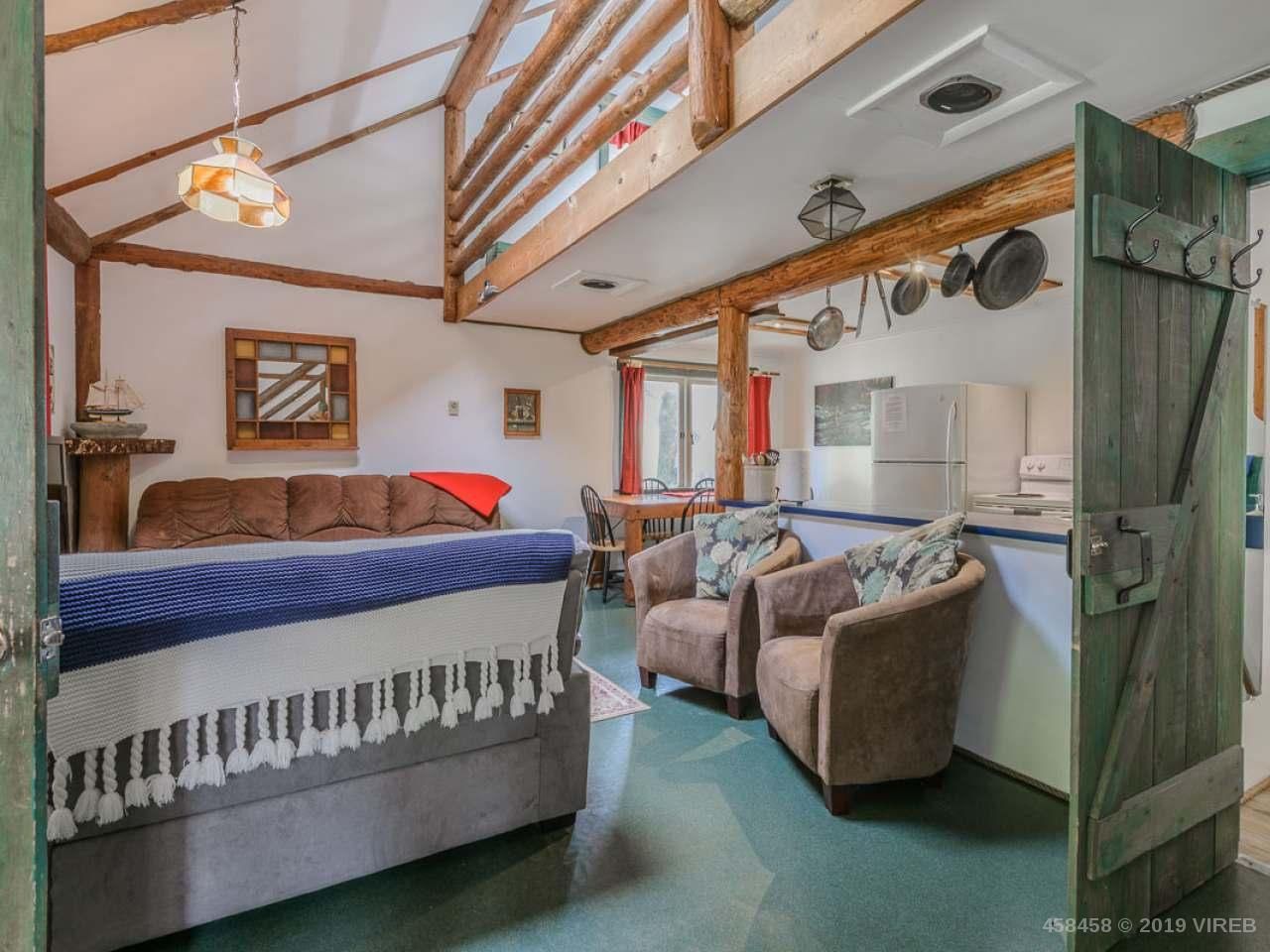 A bedroom with a bed , chairs , and a couch.