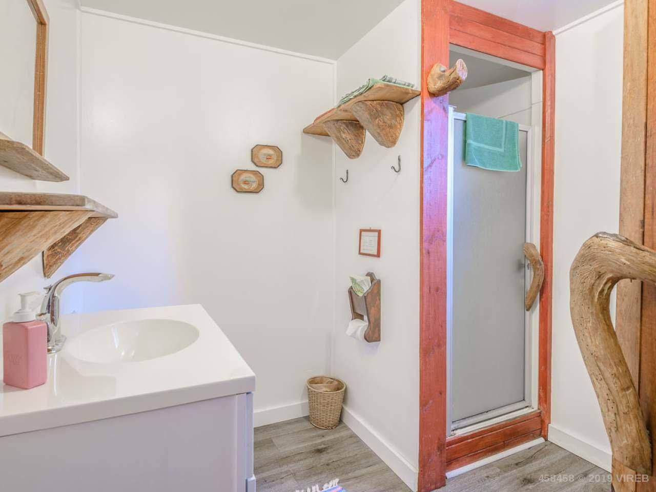A bathroom with a sink and a walk in shower.