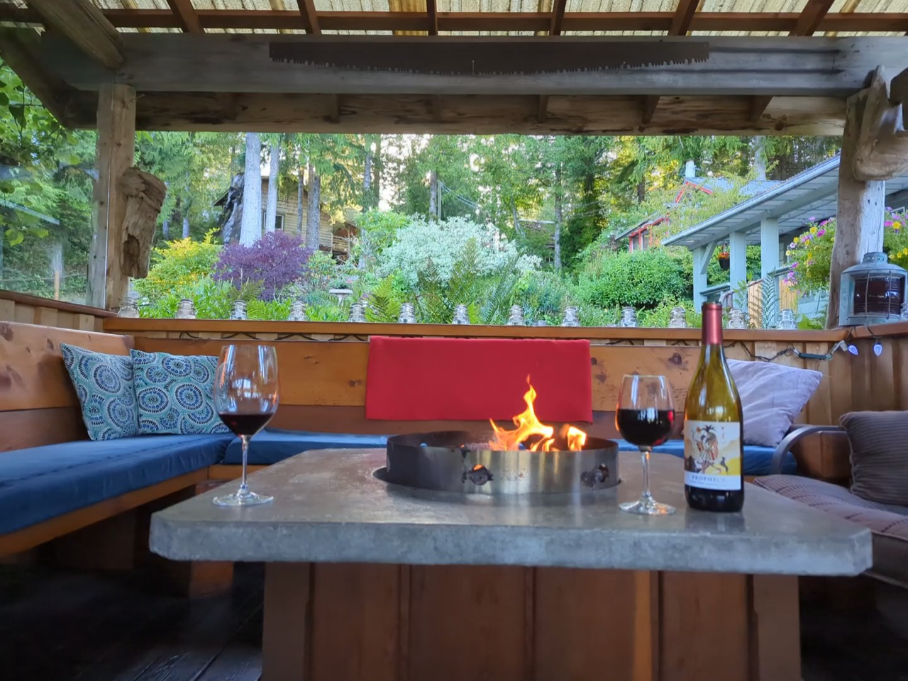 A bottle of wine is sitting on a table next to two glasses of wine.