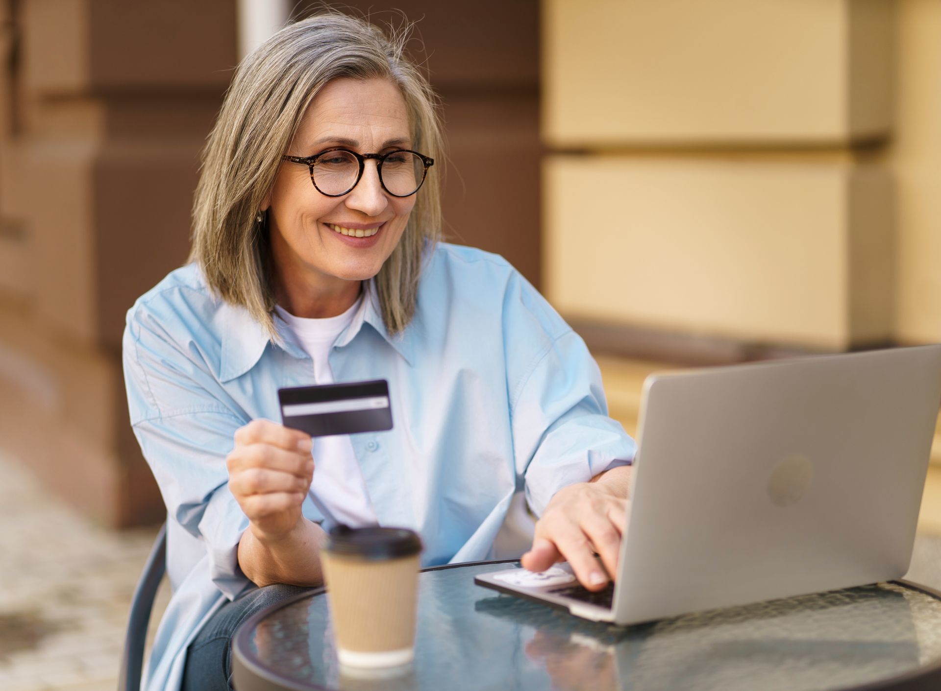 woman with credit card looking at computer