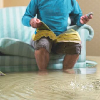 Man look for assistance for the flooded floor — Contact Us in Downingtown, PA