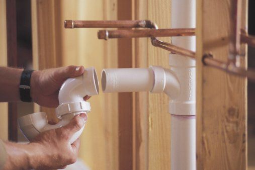 Plumber connecting PVC pipes — Plumbing Contractor in Downingtown, PA