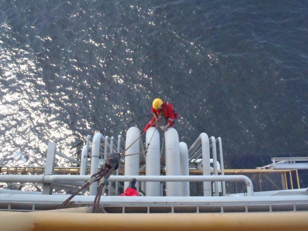 Man Inspecting with Rope