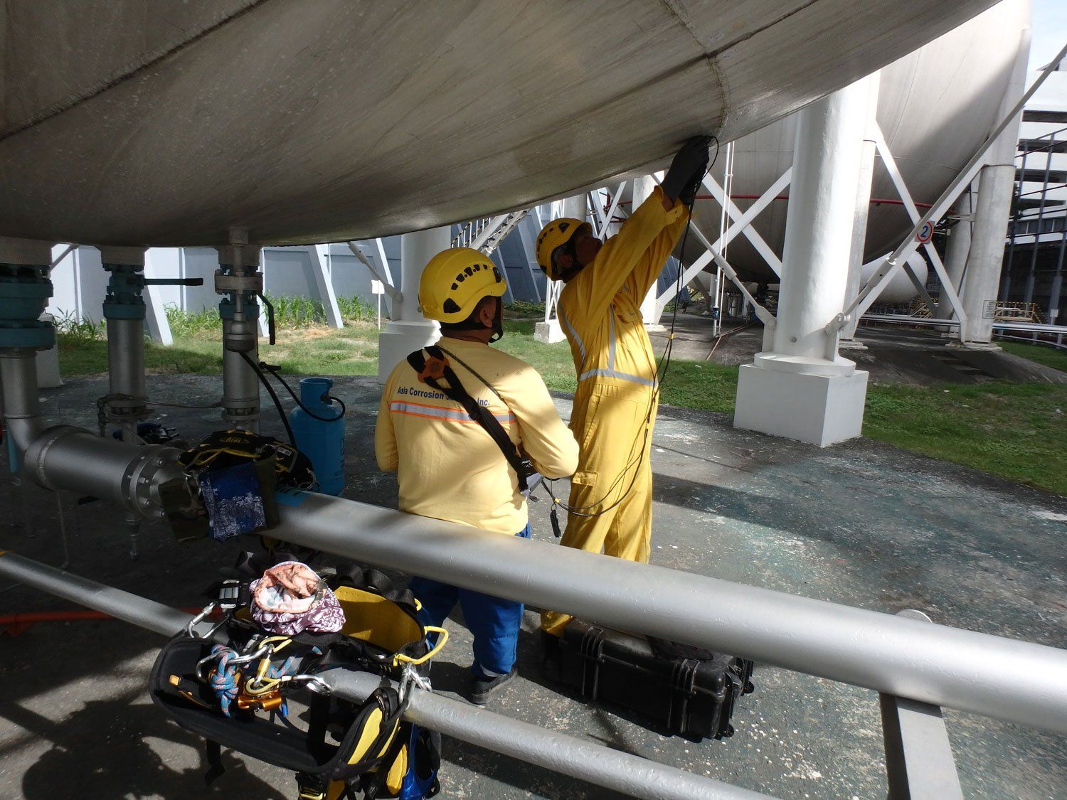 Men Working Spherical Tank