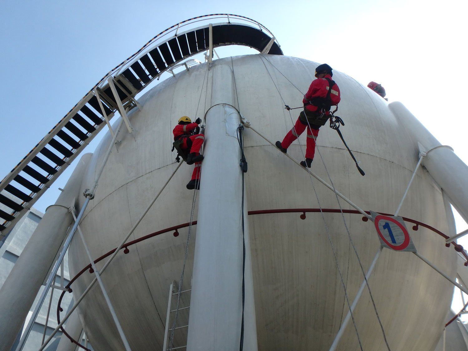 Men Working Spherical Tank