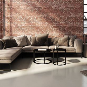 a living room with a sectional couch and two coffee tables