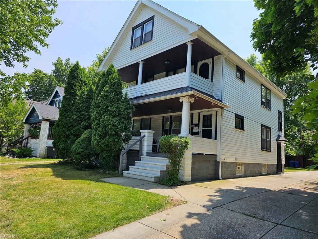 A patio with a lot of furniture and lights at night.