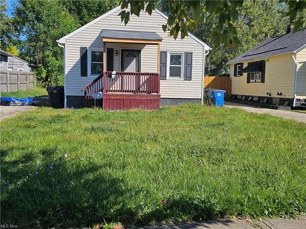 A living room with a couch , chairs , ottoman and a mirror