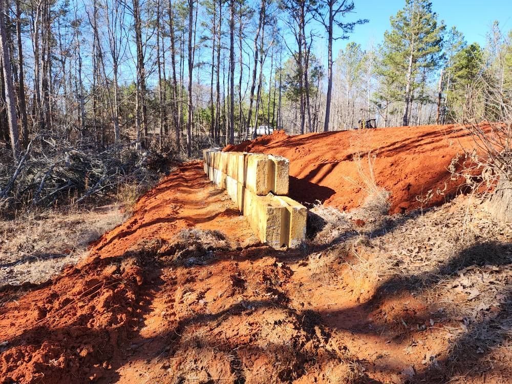 A white truck is parked in a parking lot next to a building.