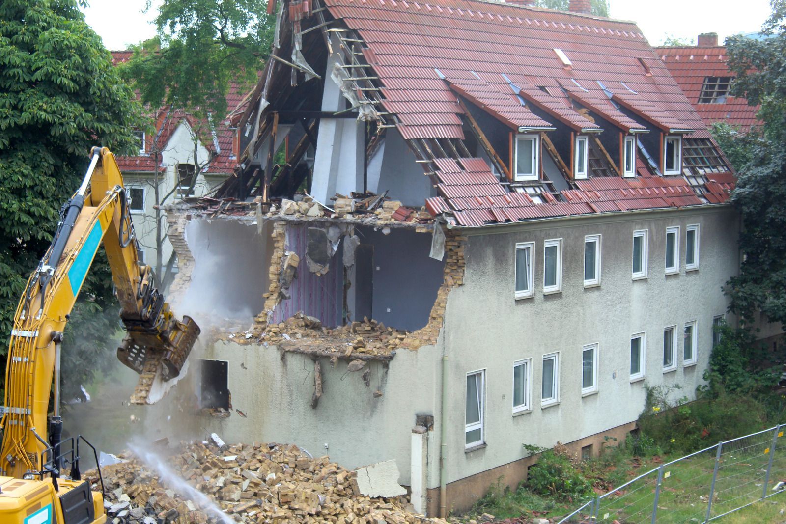 A white roof of a rv with a tree in the background