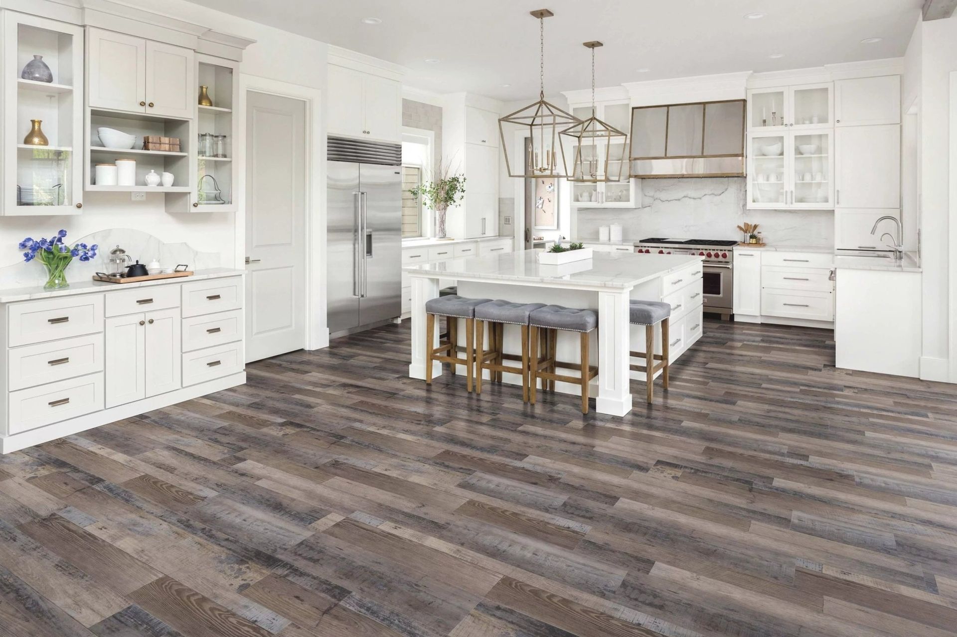 A kitchen with a wooden floor and white cabinets.