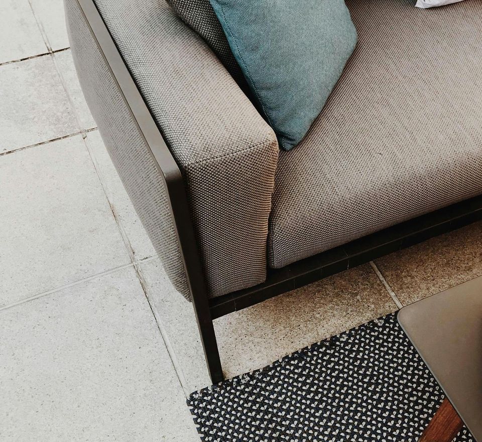 A close up of a couch with pillows on it