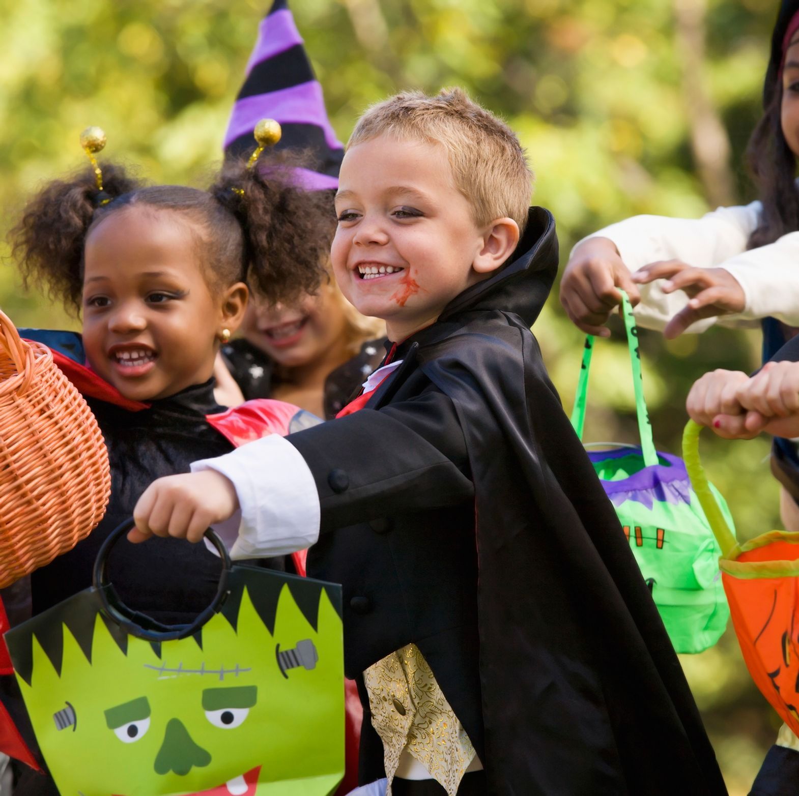 A group of children are trick or treating and one of them is wearing a frankenstein costume