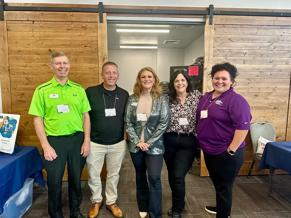 A group of people are posing for a picture in a room.